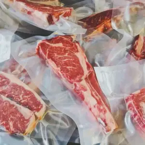 Das Bild zeigt mehrere marmorierte Stücke Fleisch verpackt in Dry Aging Beuteln.